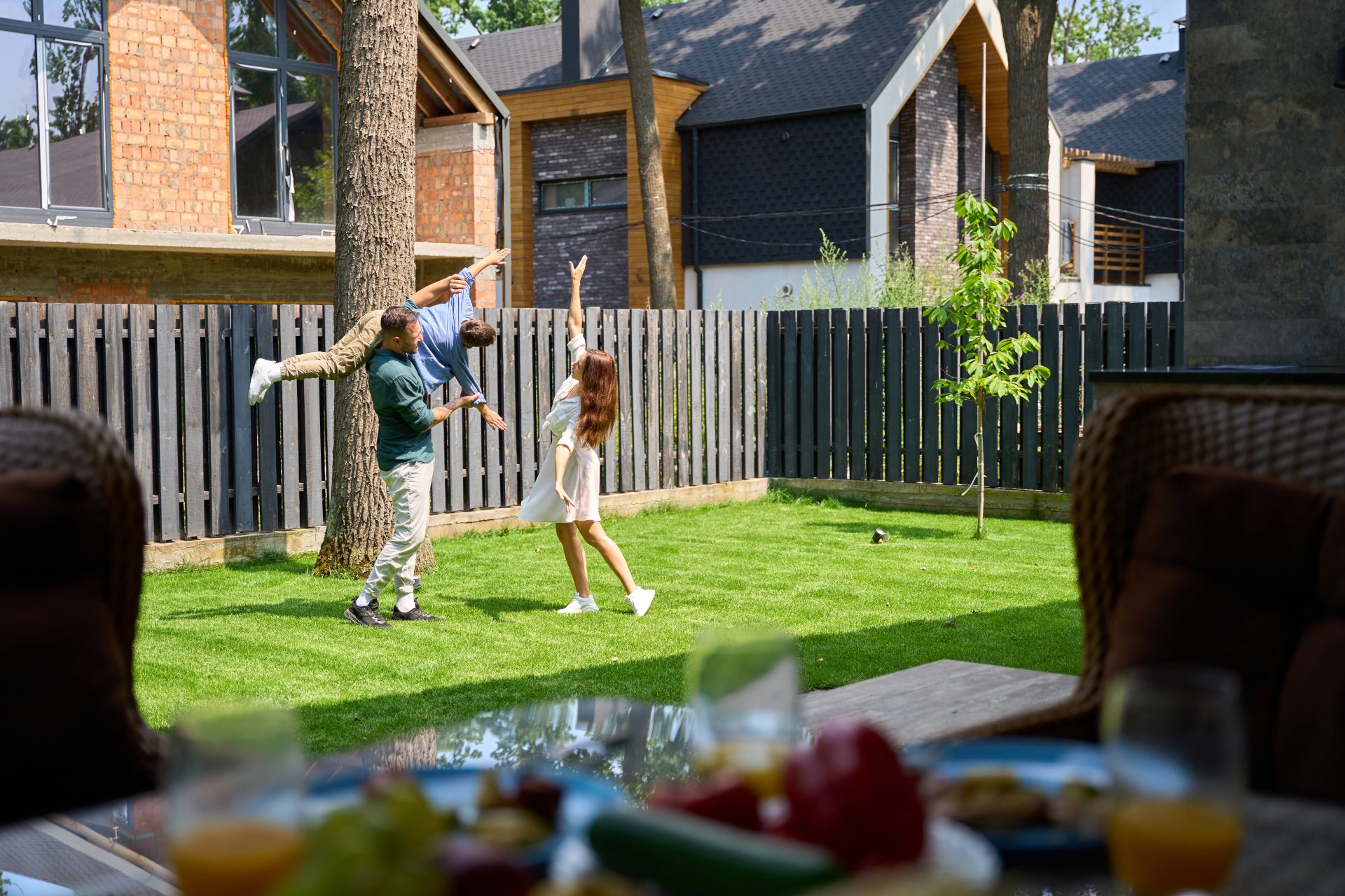 dad-mom-and-son-are-playing-happily-on-front-lawn-2025-03-09-01-54-37-utc